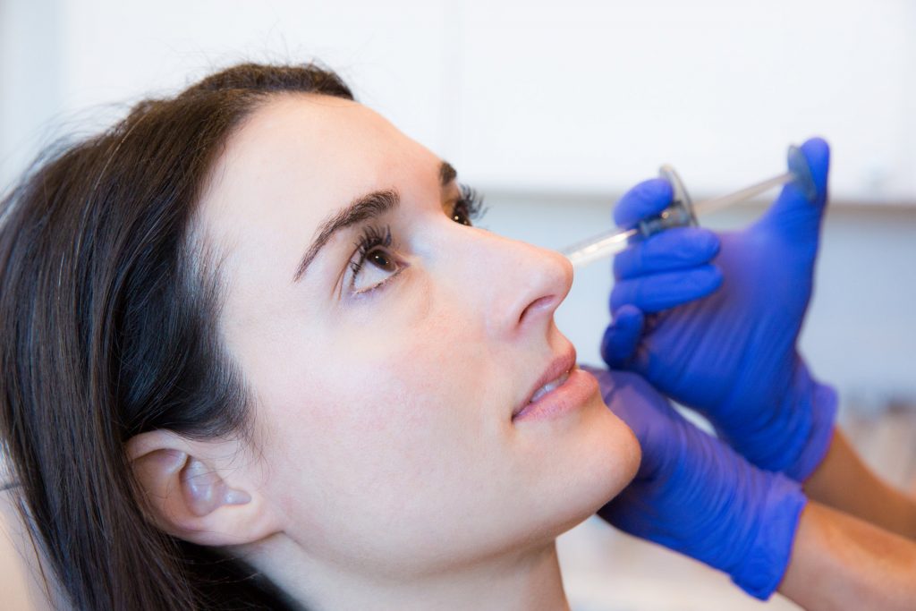 the difference between botox and fillers - juvederm injection on patient